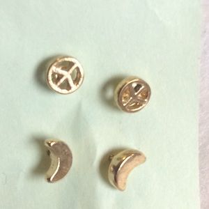 Tiny peace sign and moon studs.